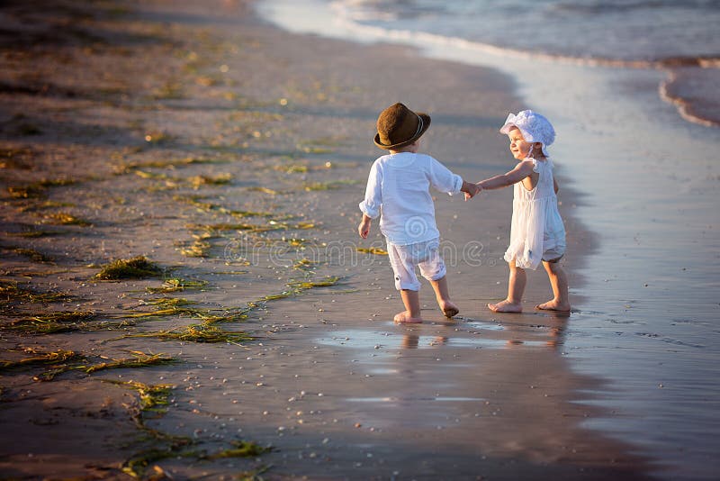 Brother and sister. Walking along the beach royalty free stock photos