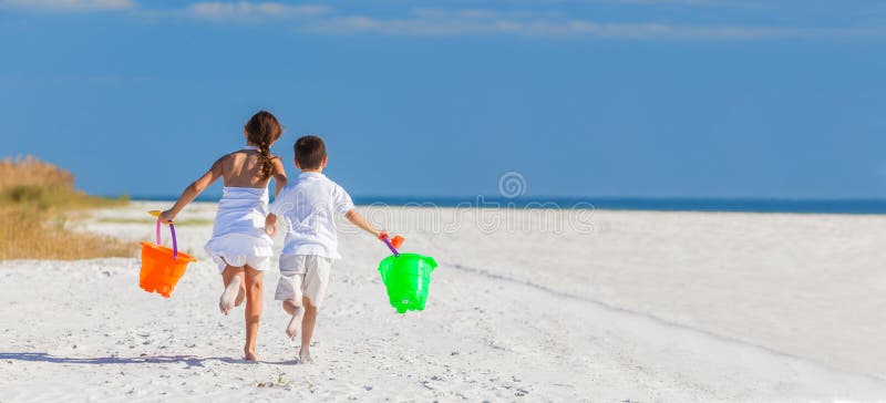 Children, Boy Girl Brother Sister Running Playing on Beach. Panoramic web banner happy children, boy girl, brother and sister running and having fun playing in royalty free stock photography