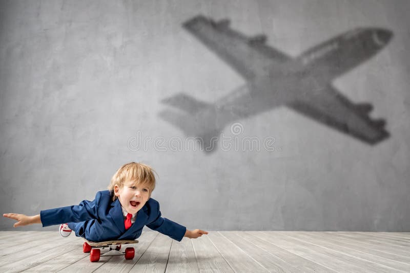 Happy child wants to fly. Imagination, freedom and motivation concept. Happy child wants to fly. Funny kid dreams of becoming a rocket. Imagination, freedom and stock photography