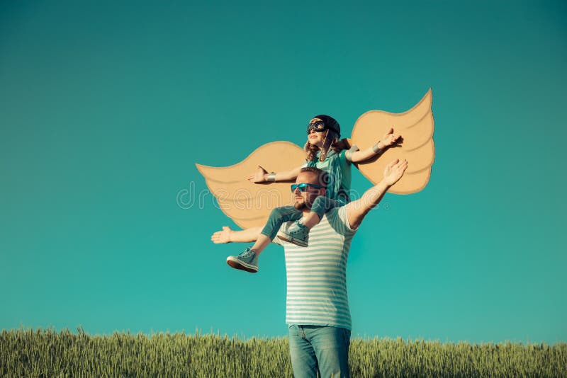 Imagination and freedom concept. Happy child playing with father outdoors. Family having fun in summer field. Travel and vacation concept. Imagination and royalty free stock images