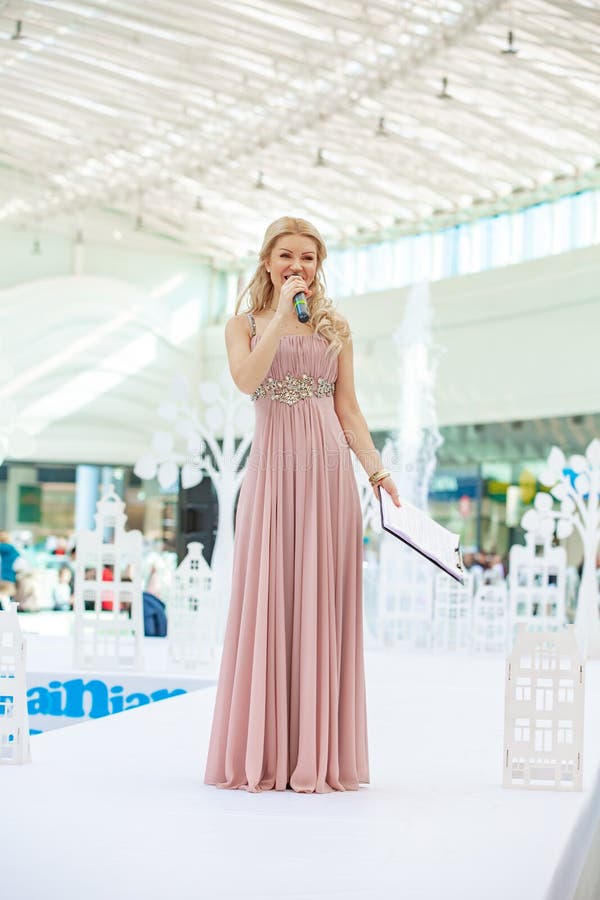 Kyiv, Ukraine March 03.2019. UKFW. Ukrainian Kids Fashion Day. Moderator of the fashion shows with microphone at the podium stock images