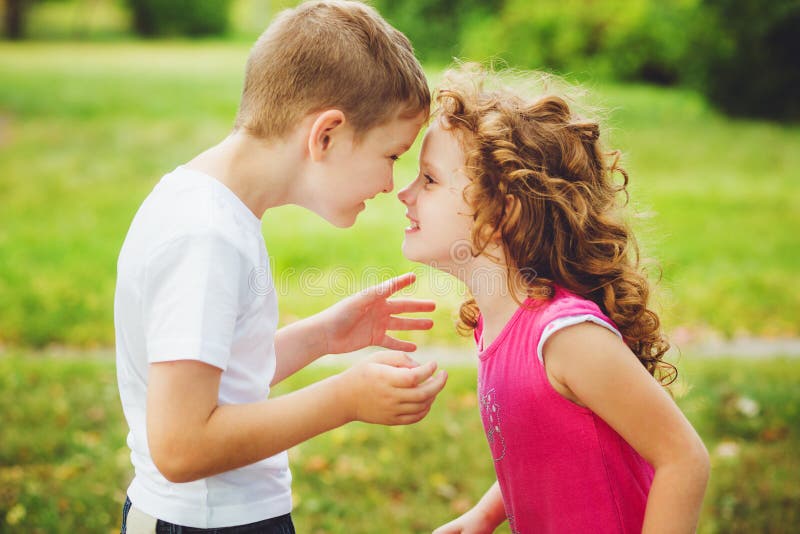 Little brother and sister confronted foreheads. Brother and sister confronted foreheads royalty free stock images