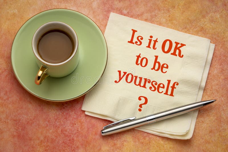 Is it OK to be yourself. ? A question on a napkin with a cup of coffee. Conformism, nonconformism, being different and individuality concept stock photos