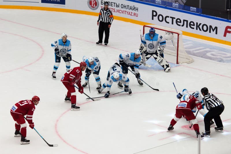 N. Komarov 19 and E. Bodrov 10 on face-off. PODOLSK - SEPTEMBER 30, 2018: N. Komarov 19 and E. Bodrov 10 on face-off during hockey game Vityaz vs Sibir royalty free stock image