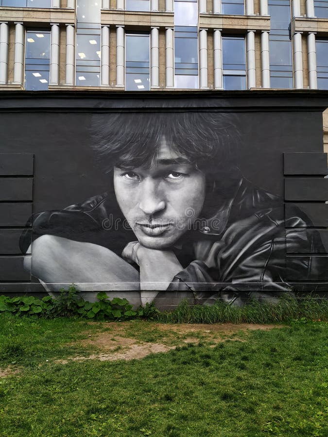 Street art portrait of famous Soviet rock musician Viktor Tsoi on the wall of a house. stock photos