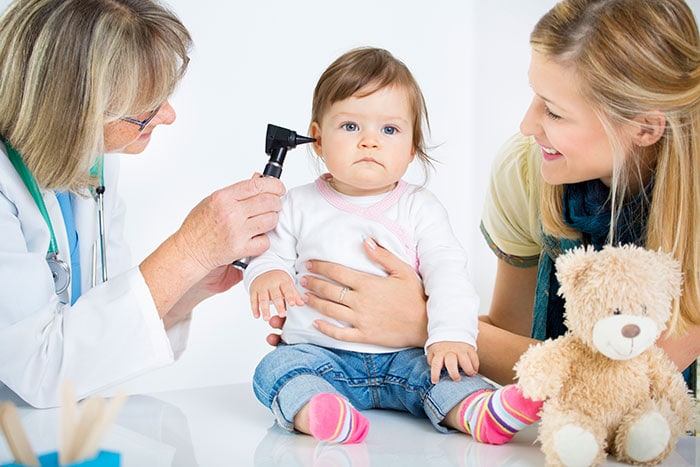 Doctor examining toddler
