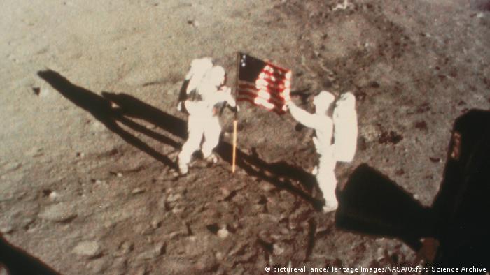 Armstrong and Aldrin unfurl the US flag on the moon.