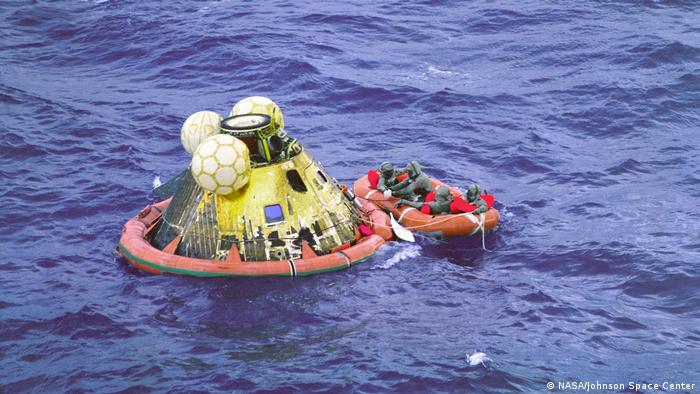Apollo 11 crew in a boat before salvage.