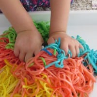 Sensory activities for kids using spaghetti - spaghetti worms in a bucket